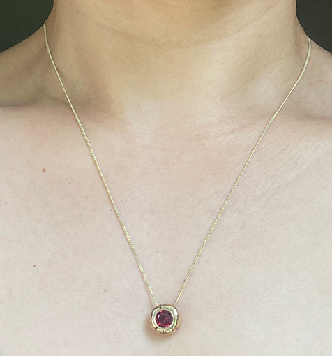 Gold charm worn
