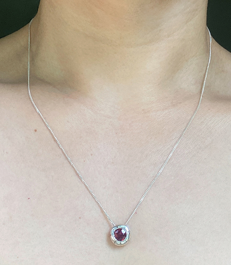 Silver charm worn