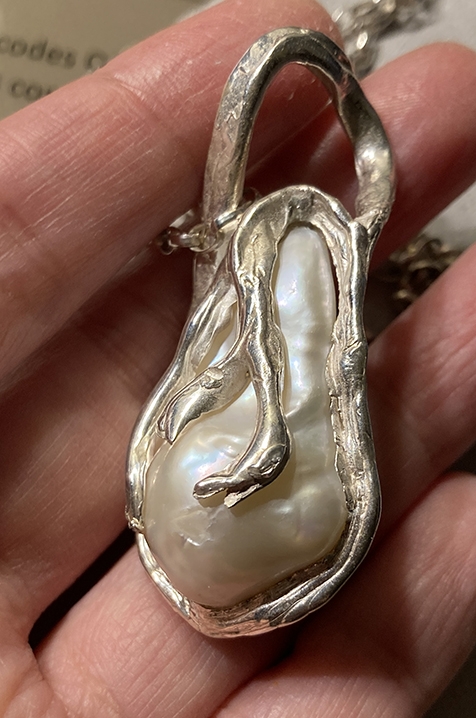 A hefty baroque pearl set in silver