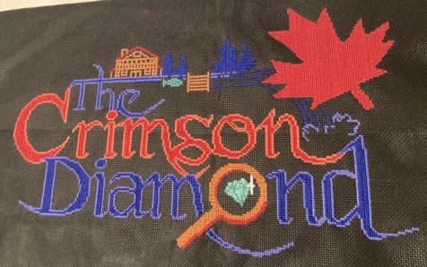 The Crimson Diamond logo cross-stitch completed